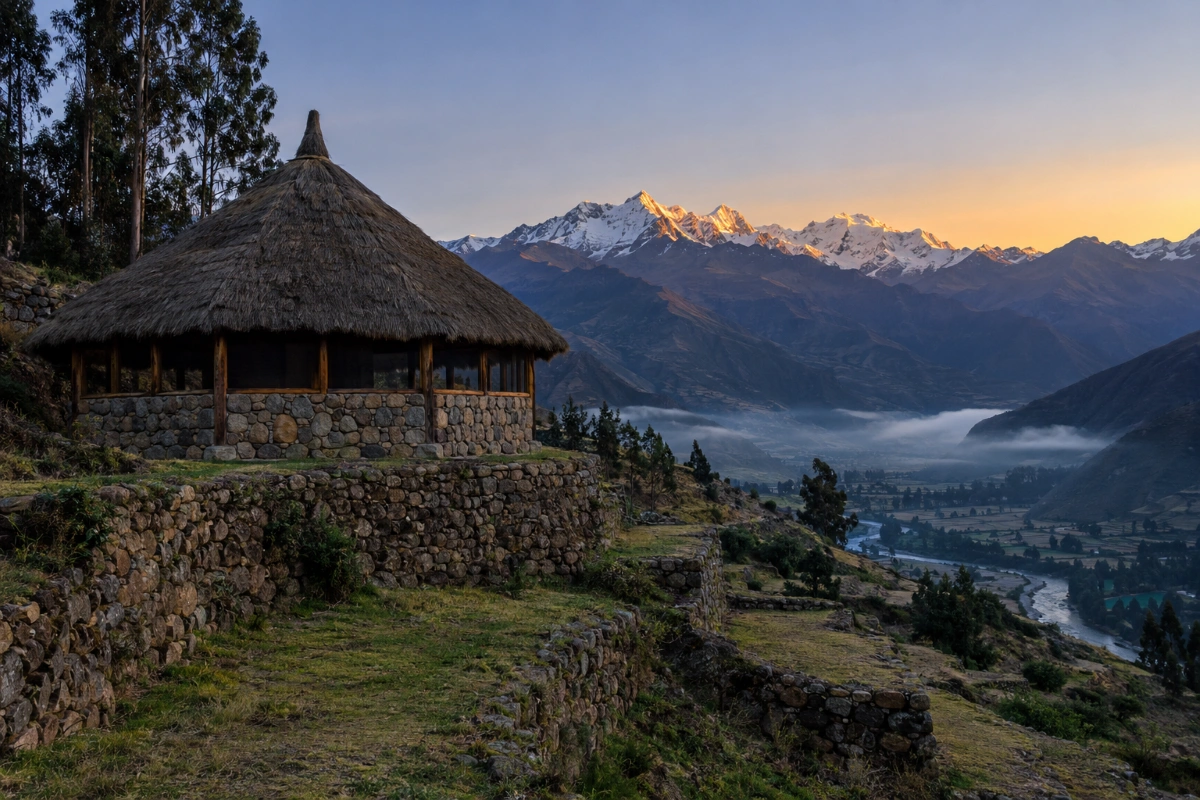 Stone maloca at dawn above the Sacred Valley where ayahuasca retreat preparation begins