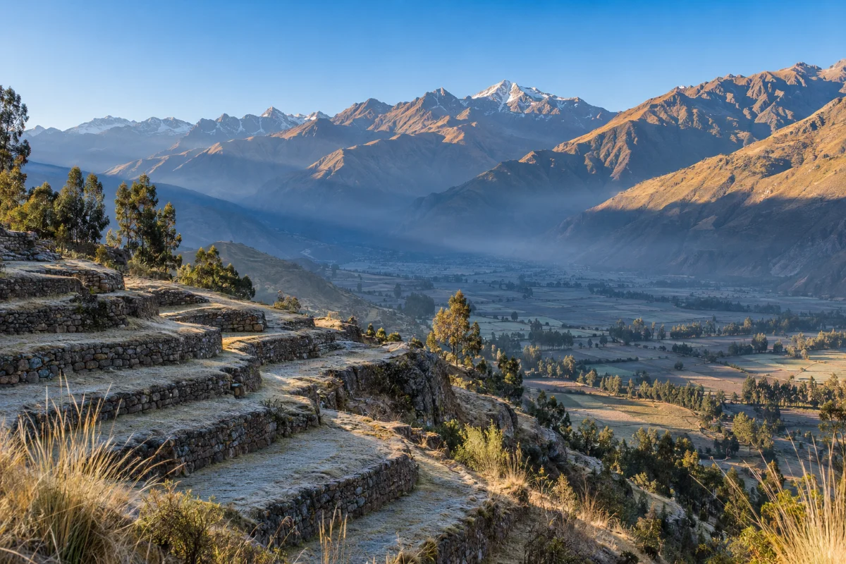 Sacred Valley at dawn from the terraces at 2,900 meters, where the ayahuasca afterglow begins
