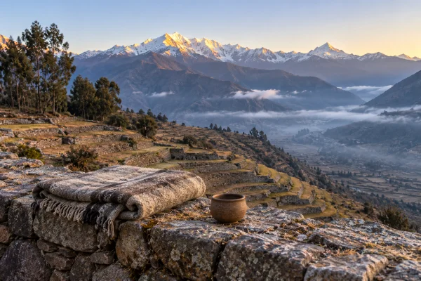 Ayahuasca or ketamine: dawn over snow-capped Andean peaks from a stone terrace near Cusco, Peru